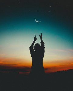 Lady reaching out to the sky