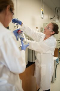 Two people in lab coats in lab