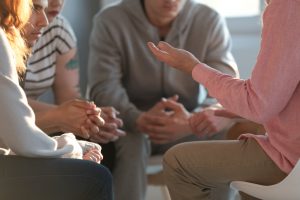 people talking in circle during group therapy