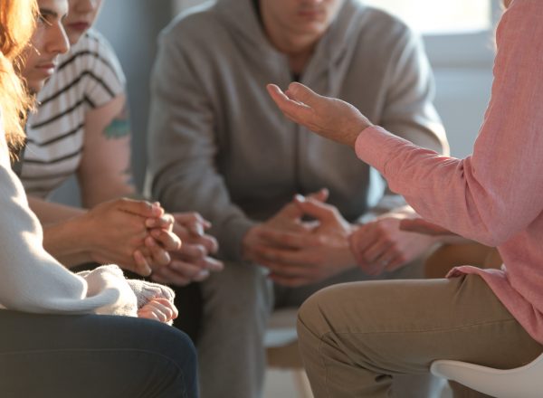 people talking in circle during group therapy