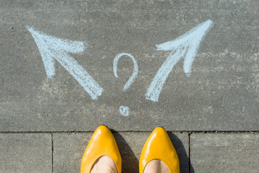 feet with two arrows in different directions in chalk