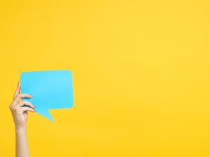 Hand with blue speech bubble
