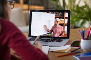 Young student watching lesson online and studying from home.