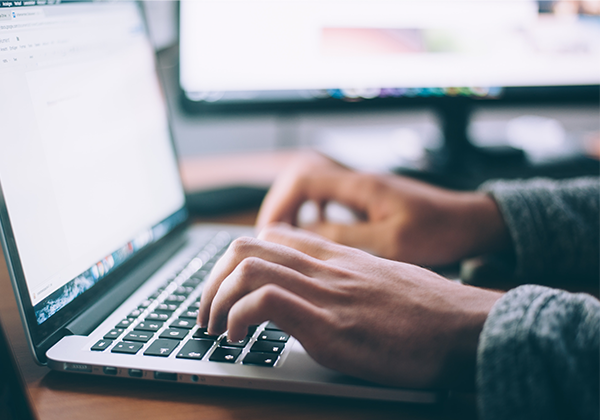 person typing on a laptop