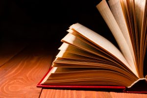 book fanned out on hardwood