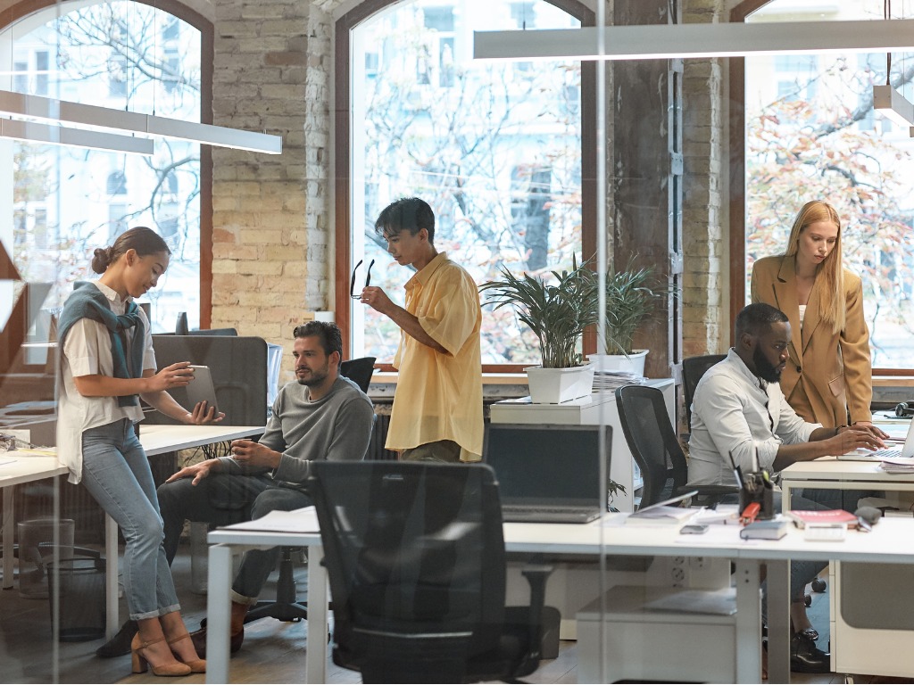 diverse group of young people working in modern office