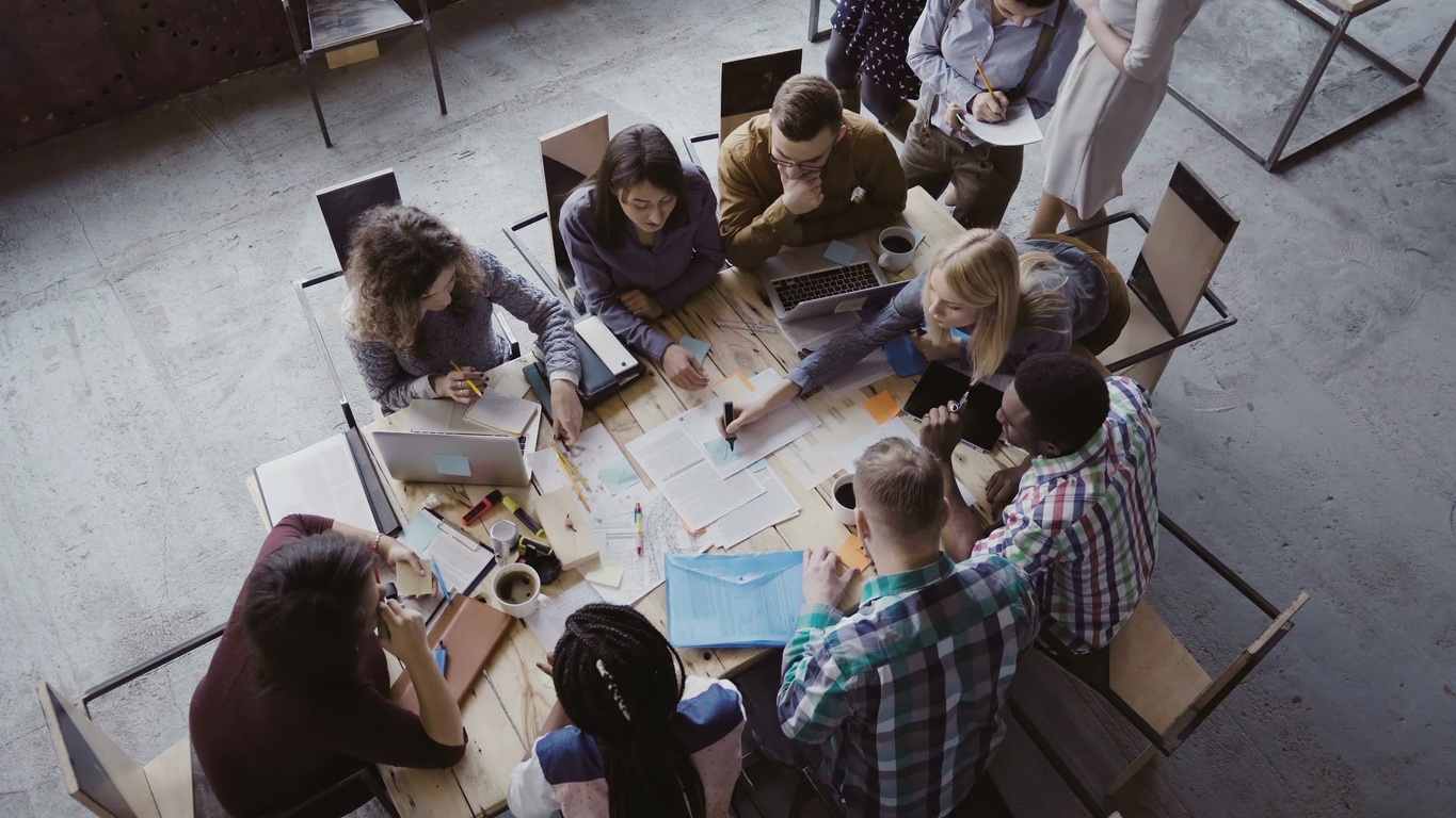 diverse group of people having meeting in industrial-style office