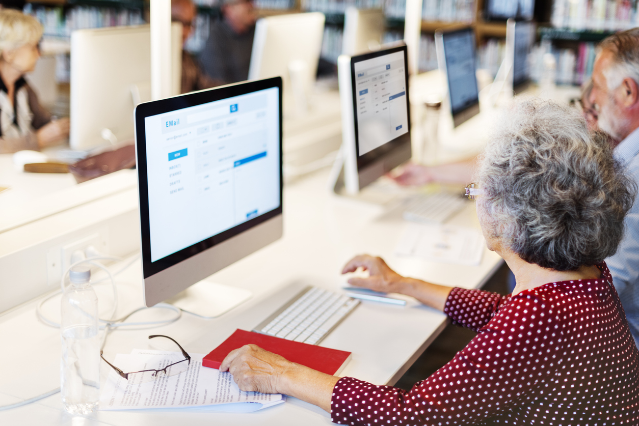 older woman using computer in computer lab