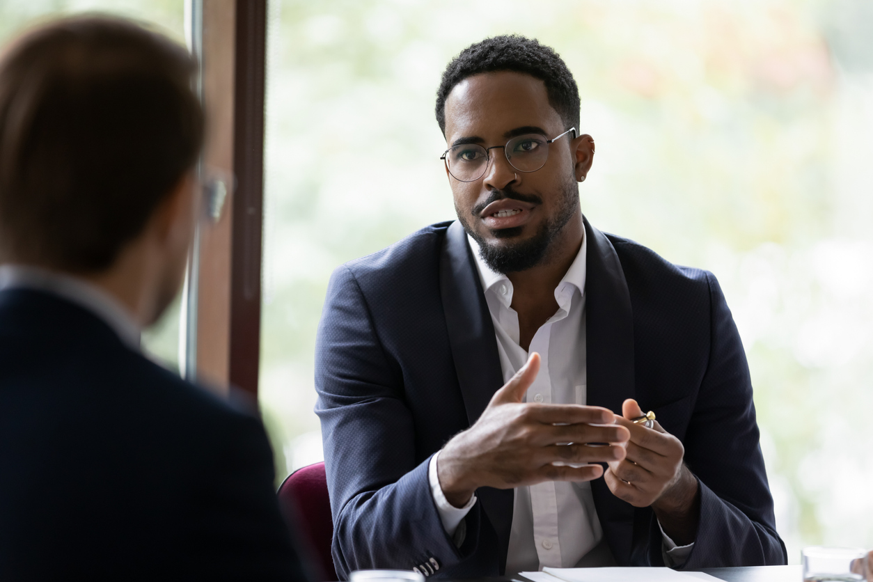 two businessmen talking in office