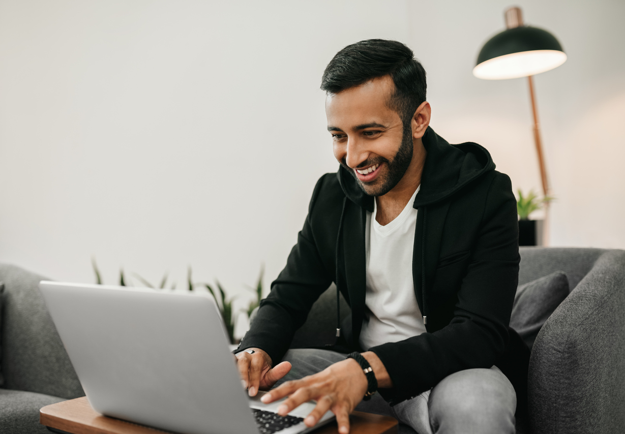 man typing on laptop