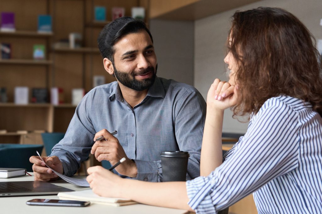 man and woman sitting and talking