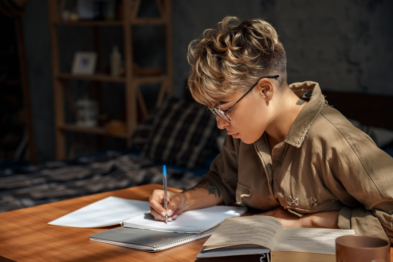 university student working on homework at desk