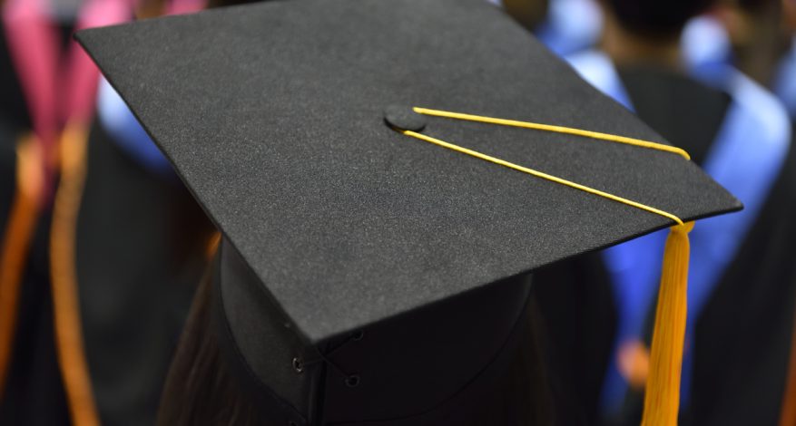 Back of head of student wearing graduation cap during convocation.