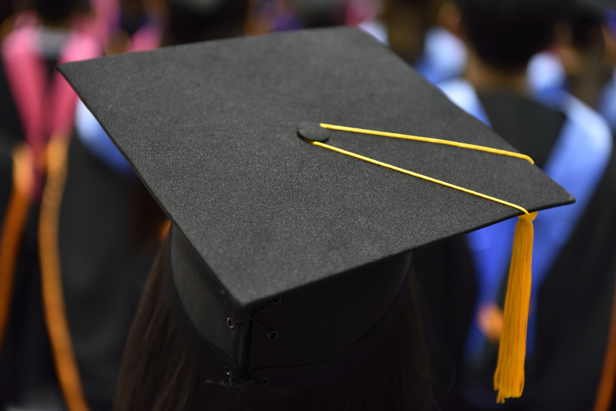 Back of head of student wearing graduation cap during convocation.