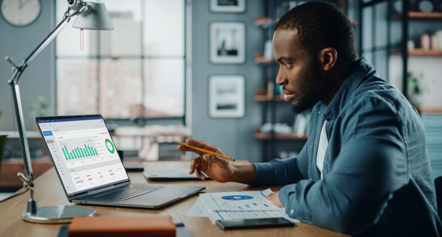 Black man working on laptop in home office
