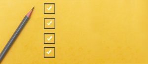 Pencil beside checkboxes on yellow background