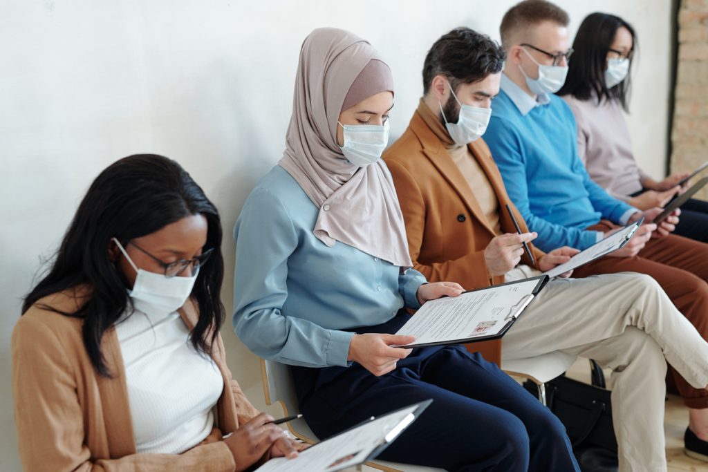 Young job applicants in waiting room before interview.