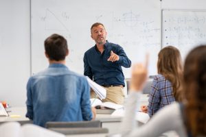 Teacher and students in high school classroom