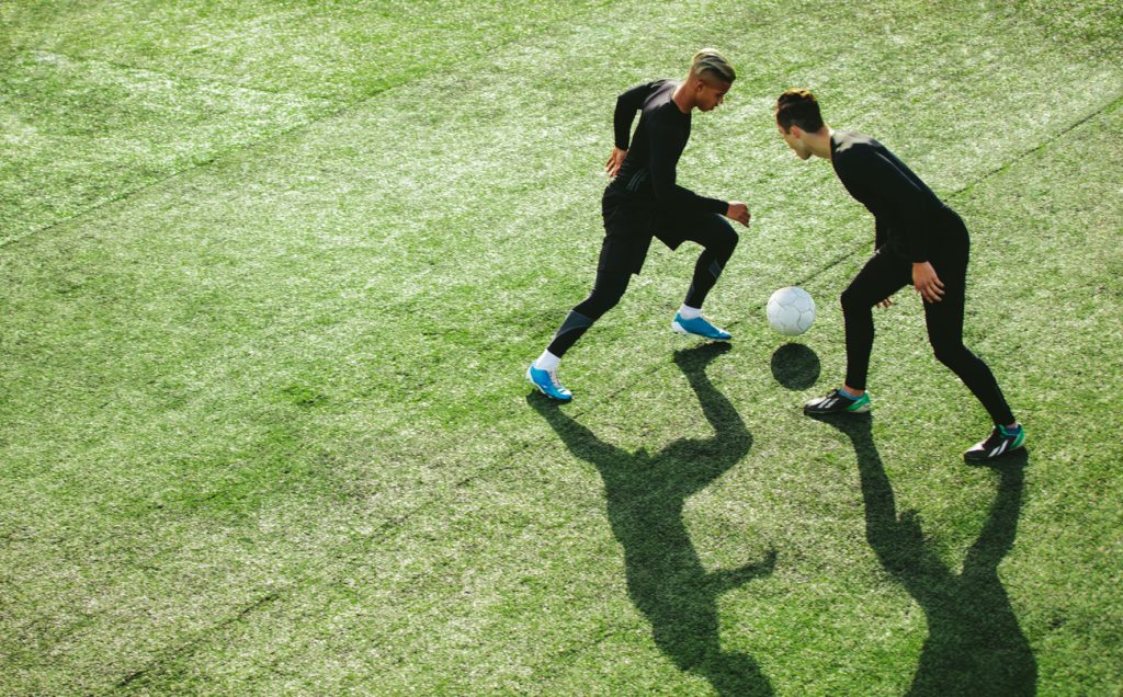 Two male soccer players on field