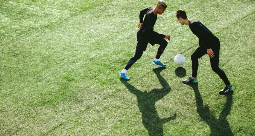 Two male soccer players on field