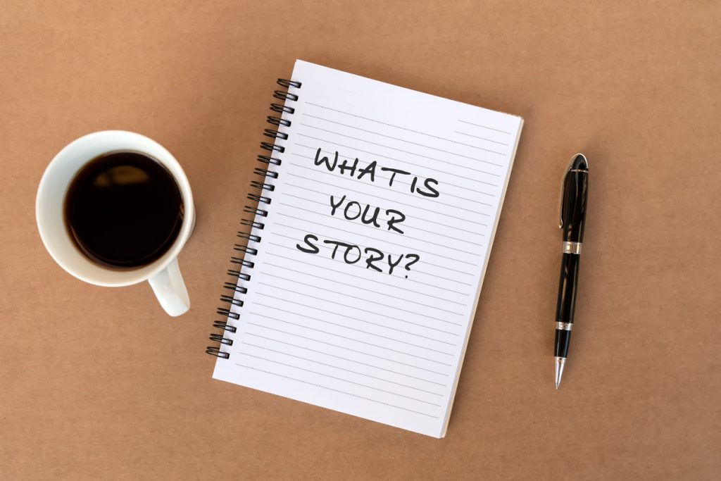 Open notebook with "What is your story?" written on it