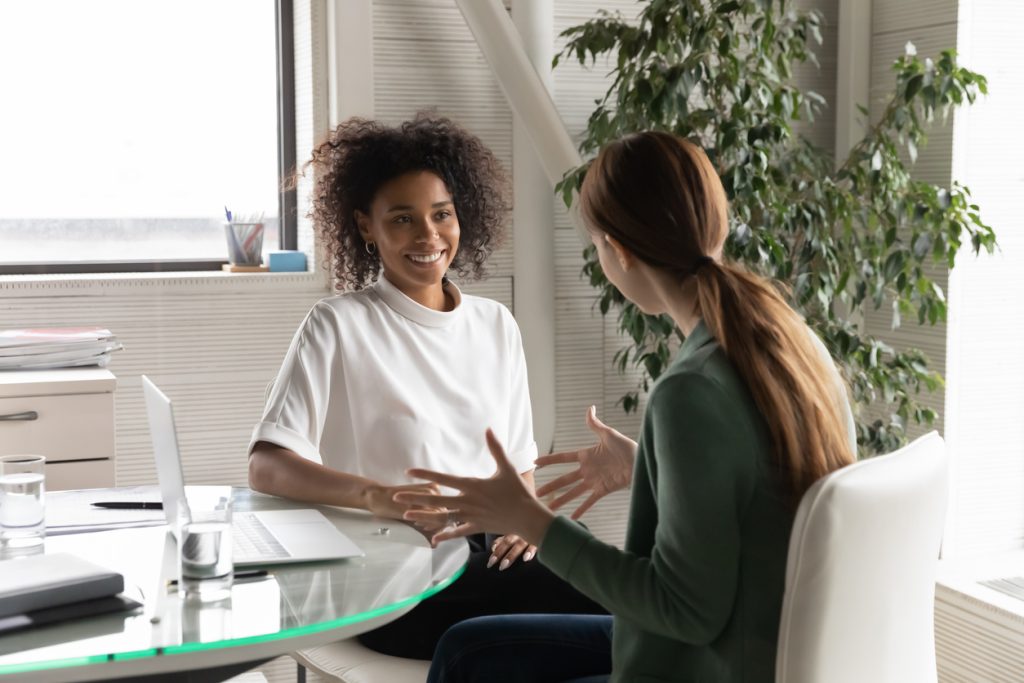 Two women talking in office