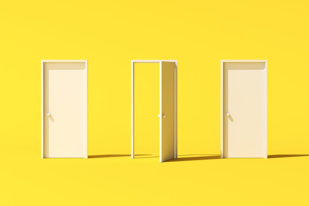Three white doors on yellow background