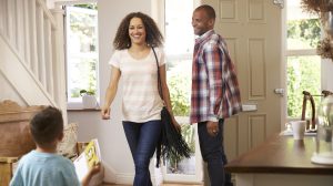 Father Opens Front Door For Mother Returning Home From Work