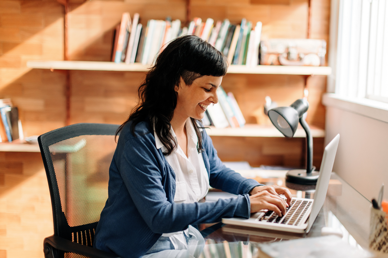 Smiling woman working in her home office.